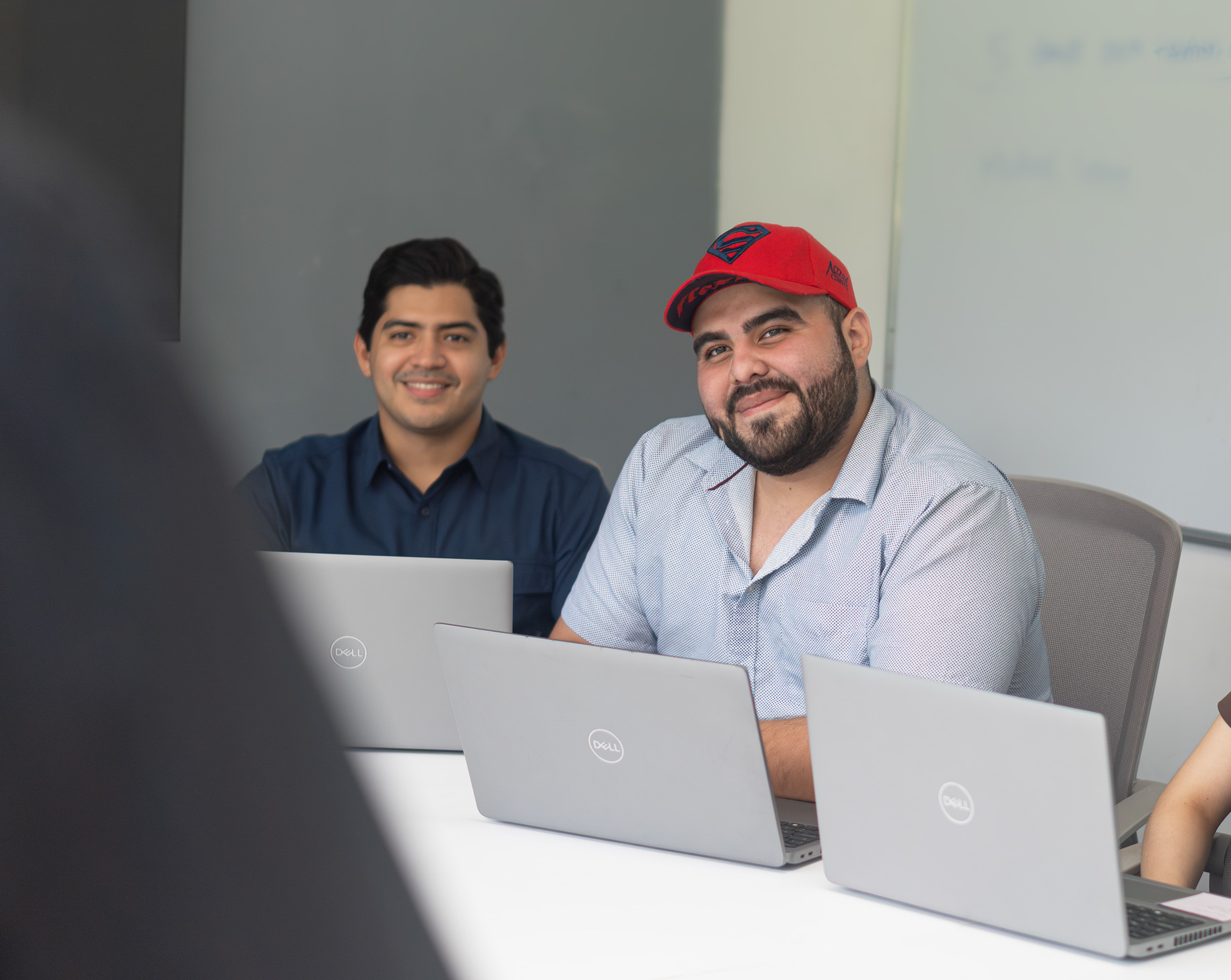 Two Work Ninjas teammates laughing over a laptop
