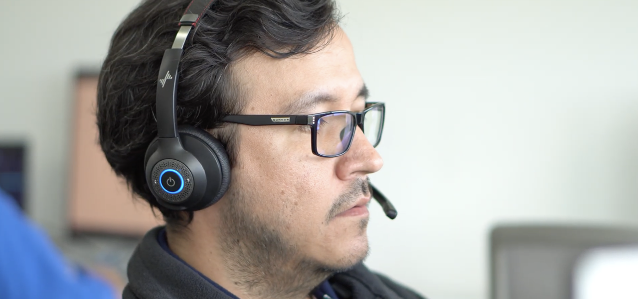Work Ninjas customer service agent on a headset in the office